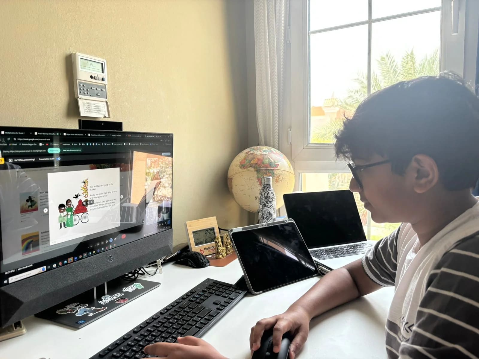 A young volunteer leads an online reading session from a desk.