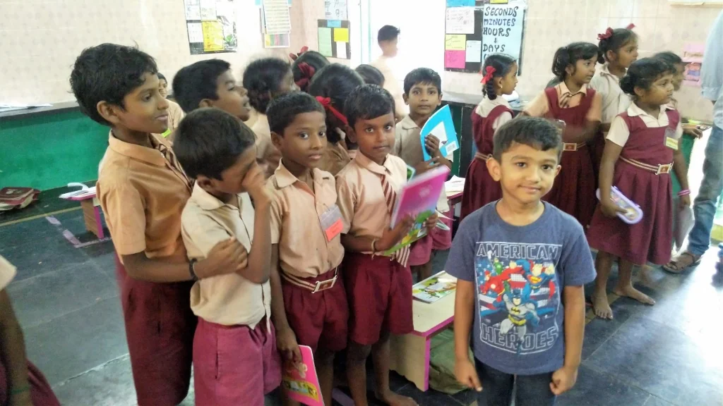 Vrishank with pupils and teachers in an Arumbakkam classroom
